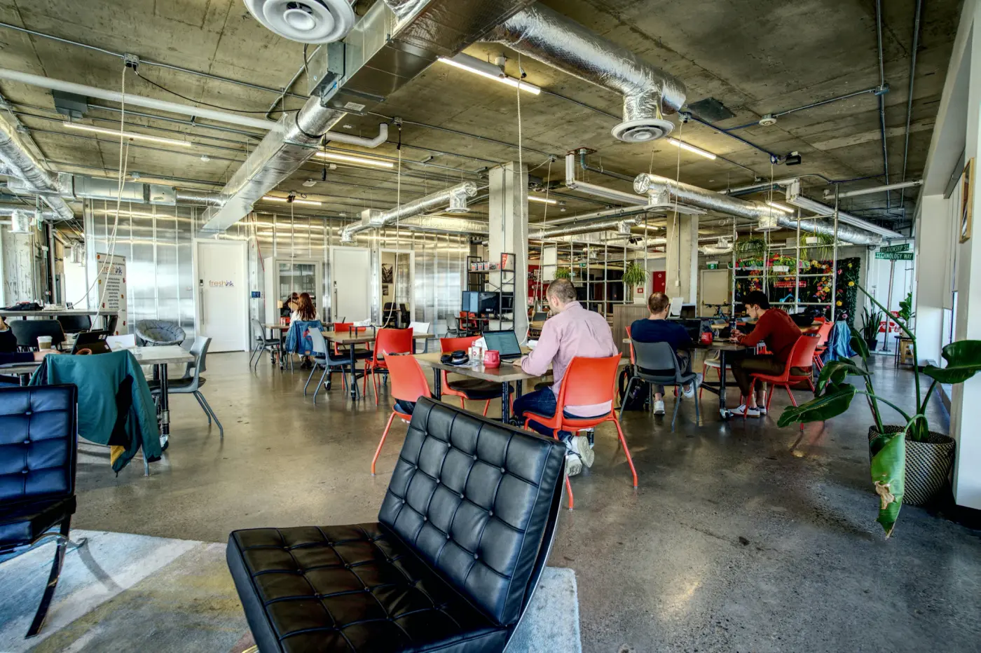 Members at shared tables inside Red Mile