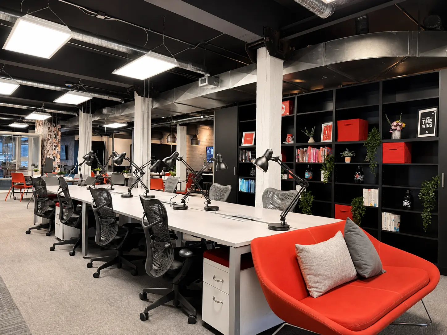 A row of dedicated desks with lamps at Westcoast