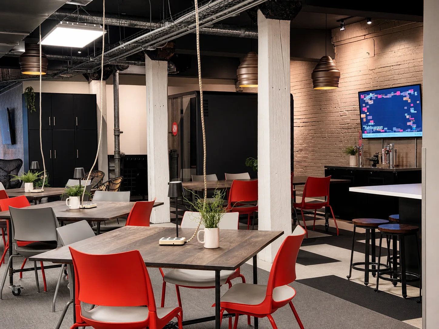 Long wooden tables with red chairs in the Westcoast kitchen